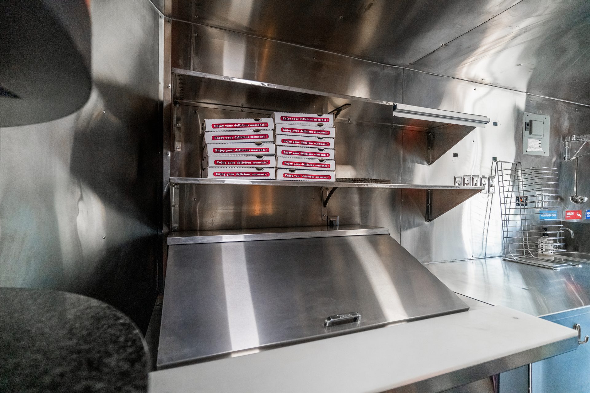 Stainless steel interior with shelves and pizza boxes