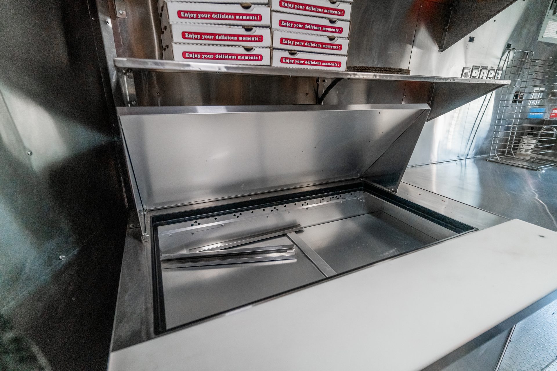 Stainless prep area and pizza boxes