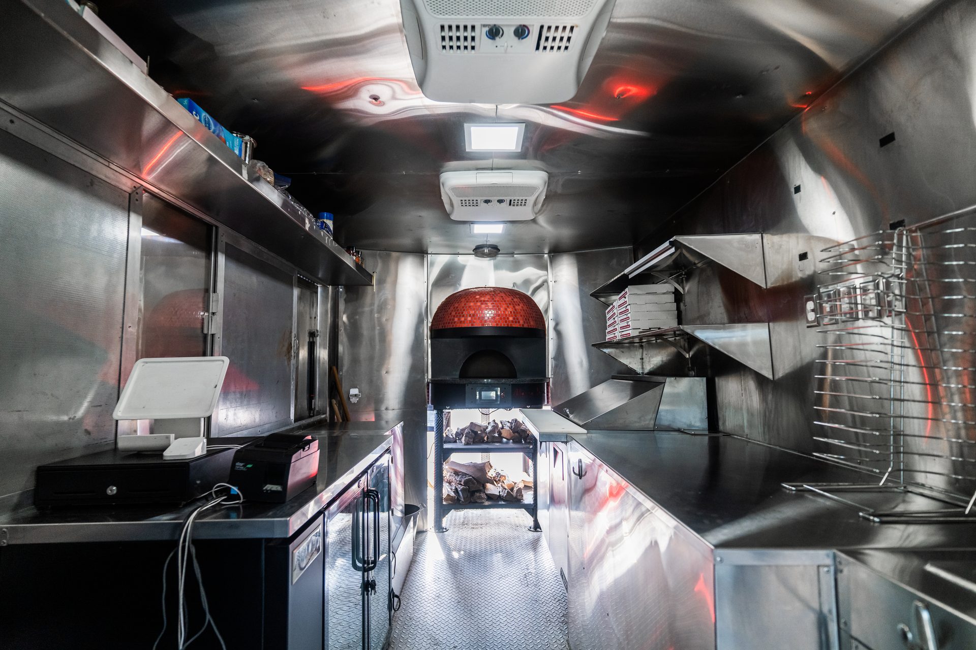 Interior featuring brick oven, stainless counters, and equipment
