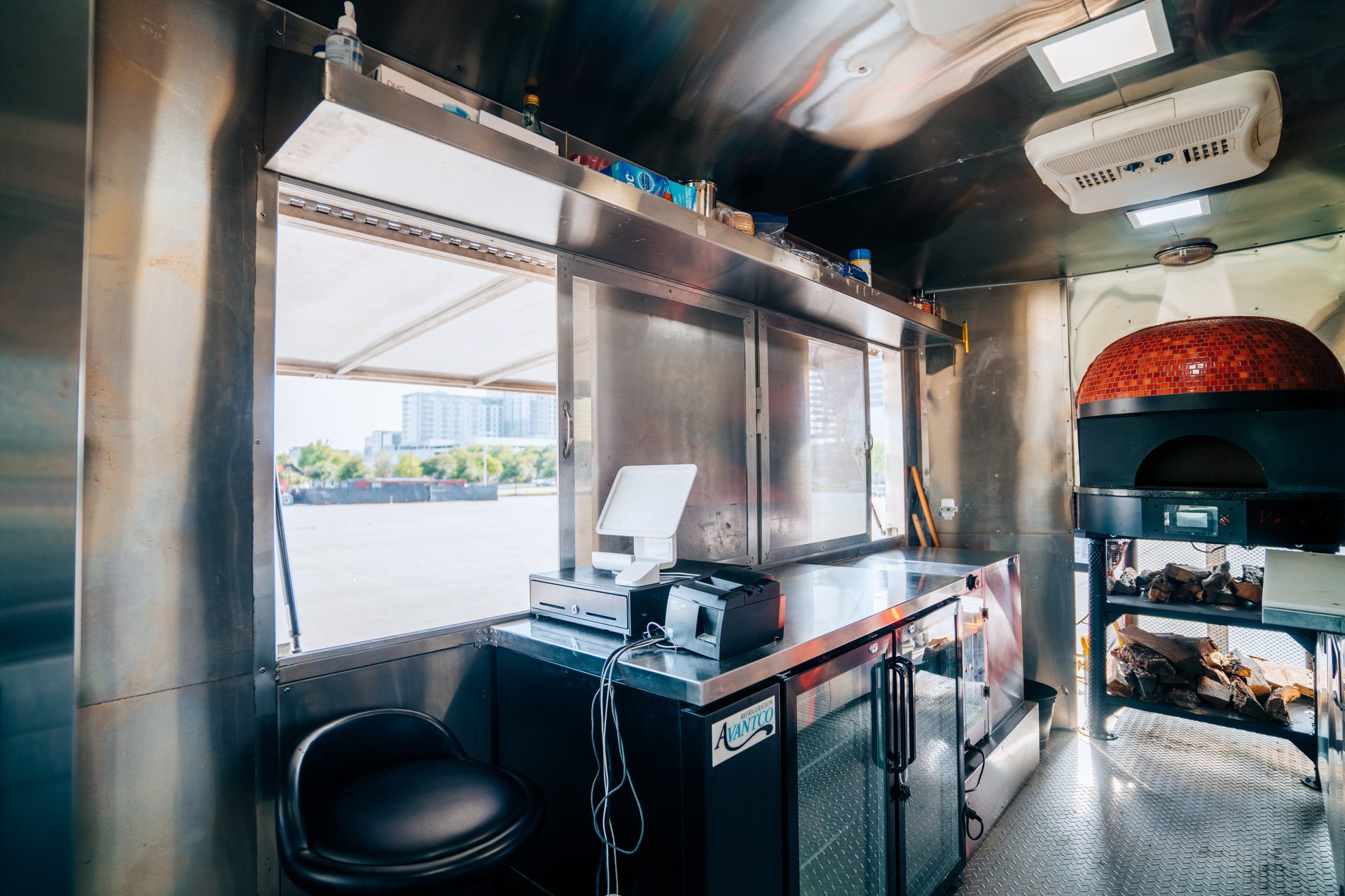 Interior with brick oven, counter, and serving window