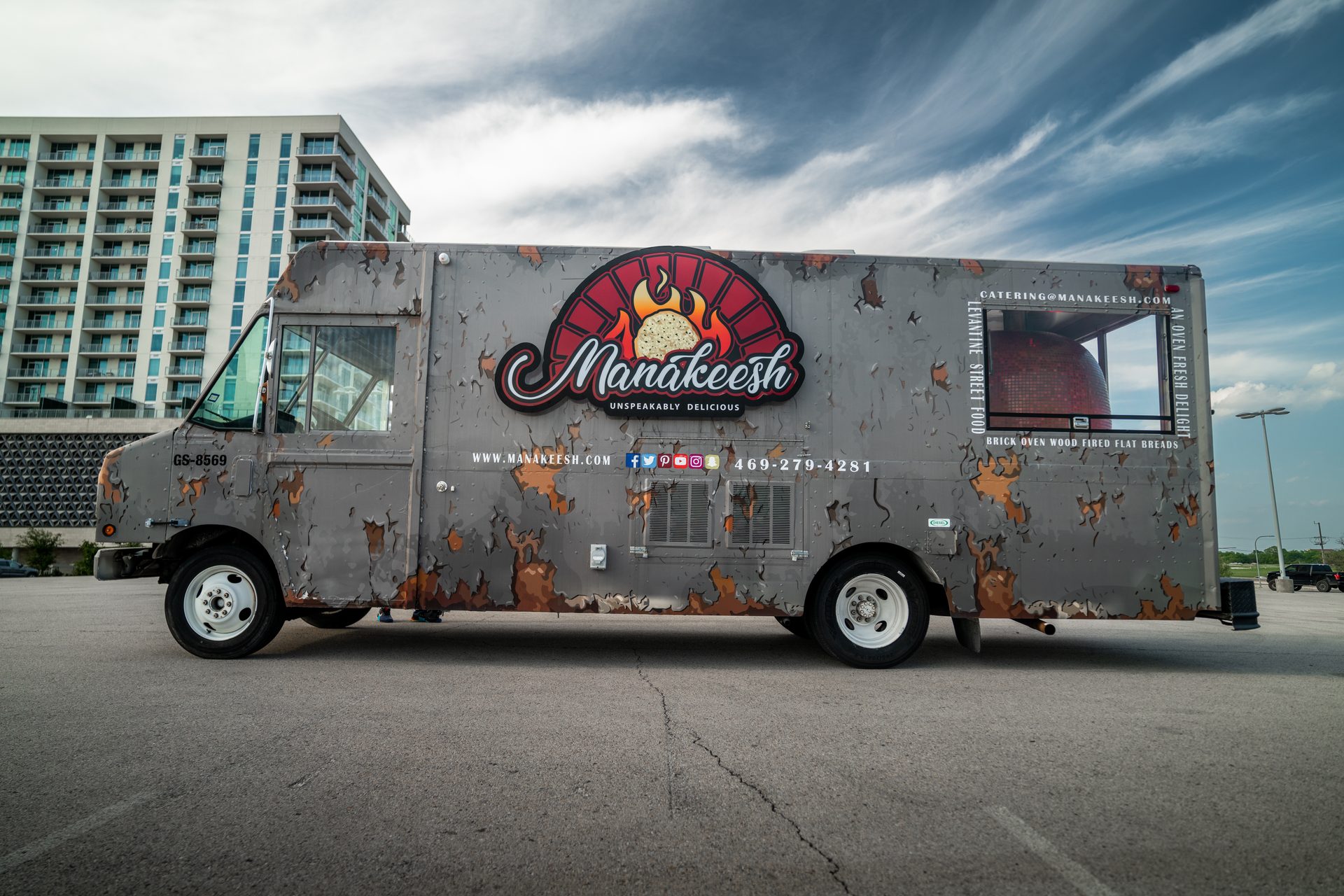 Full exterior with branding and visible brick oven