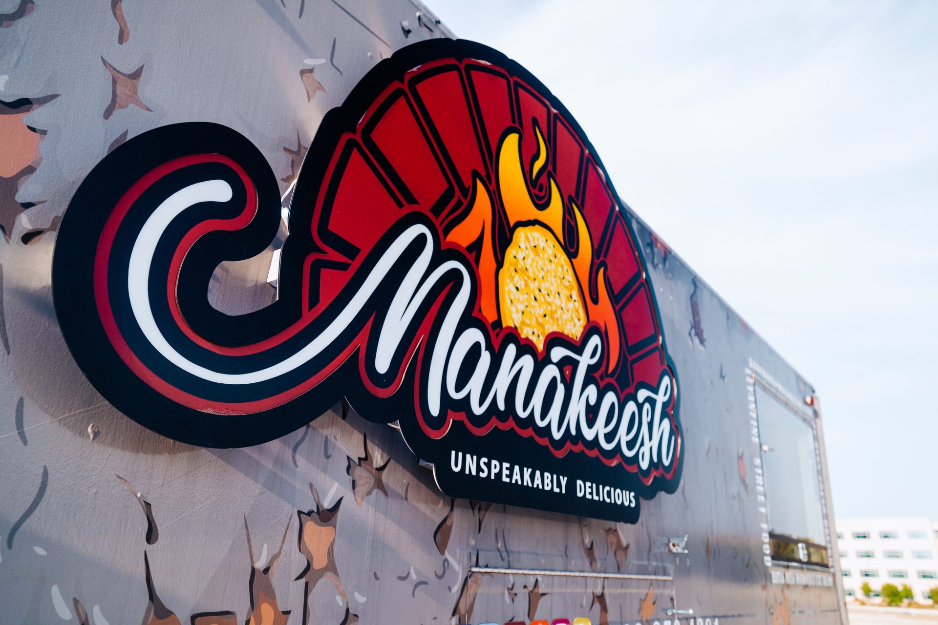 Side of the truck with Manakeesh logo