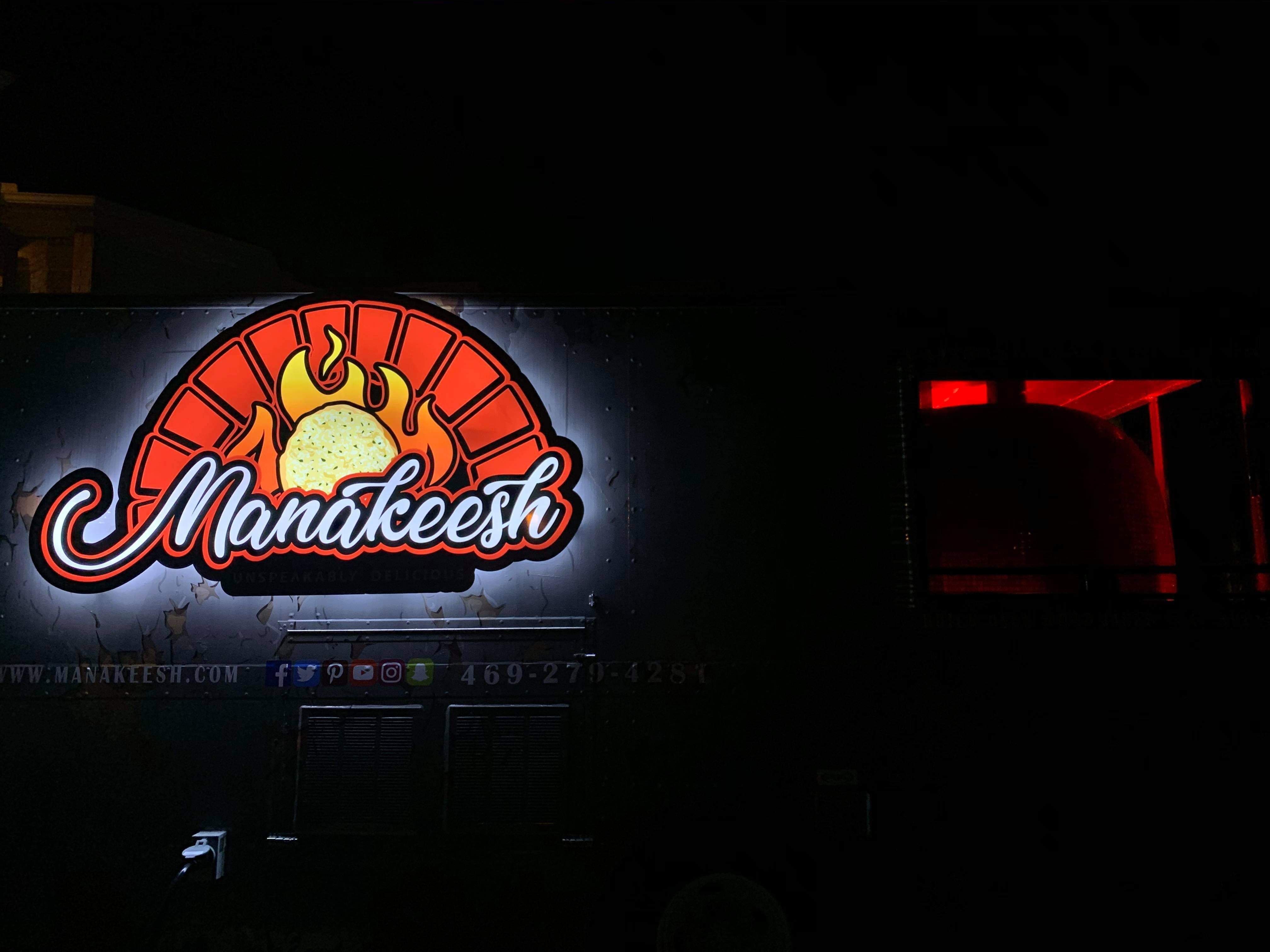 Manakeesh sign lit at night